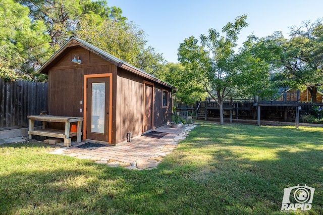 view of outbuilding featuring a yard