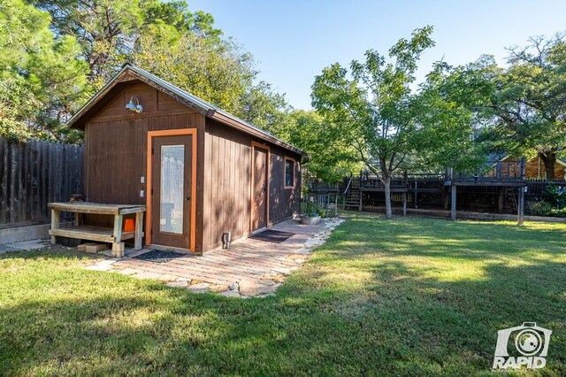 view of outbuilding featuring a yard