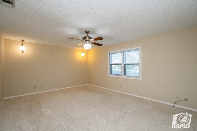 unfurnished room featuring ceiling fan and a textured ceiling