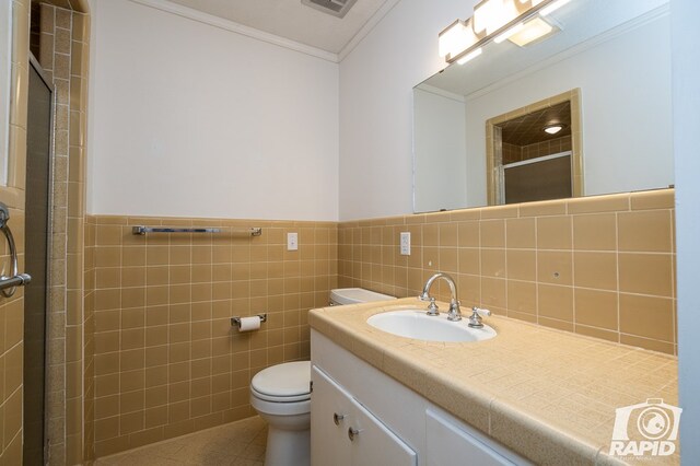 bathroom featuring tile walls, tile patterned flooring, ornamental molding, walk in shower, and toilet