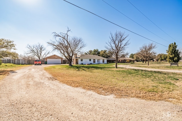 view of front of home with a garage and a front lawn