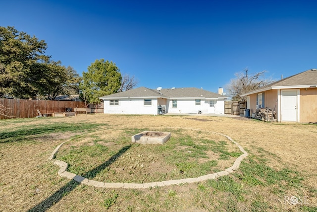 rear view of house featuring a yard