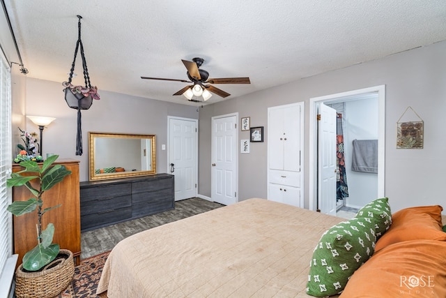 bedroom with ceiling fan, dark hardwood / wood-style floors, and a textured ceiling