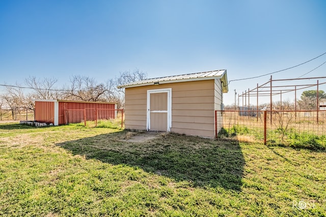 view of outbuilding with a yard