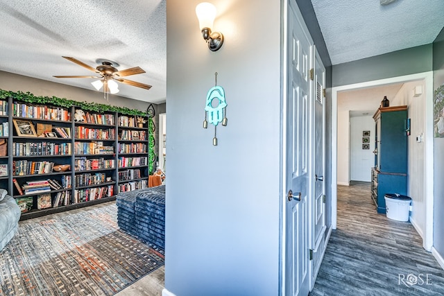 hall with dark wood-type flooring and a textured ceiling