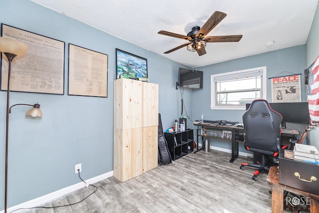 office area featuring ceiling fan, a textured ceiling, and light wood-type flooring