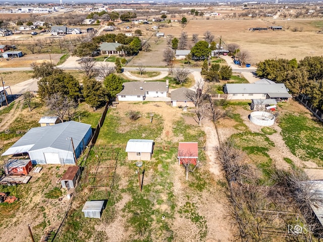 birds eye view of property with a rural view