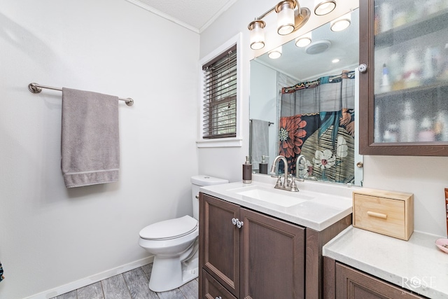 bathroom featuring toilet, hardwood / wood-style flooring, vanity, walk in shower, and crown molding