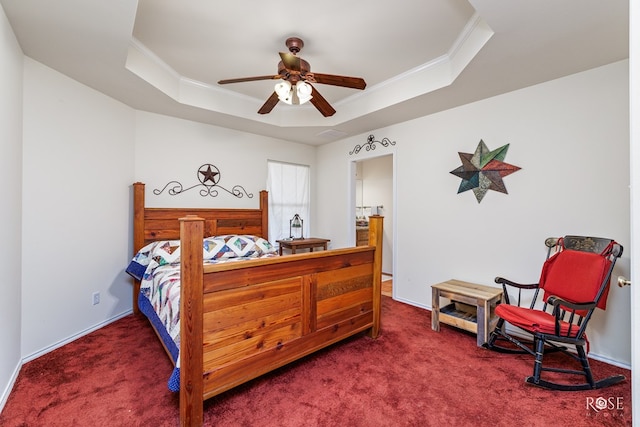 bedroom with a tray ceiling, crown molding, and carpet