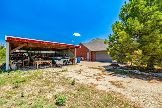 exterior space featuring a pole building, an outdoor structure, and an attached garage