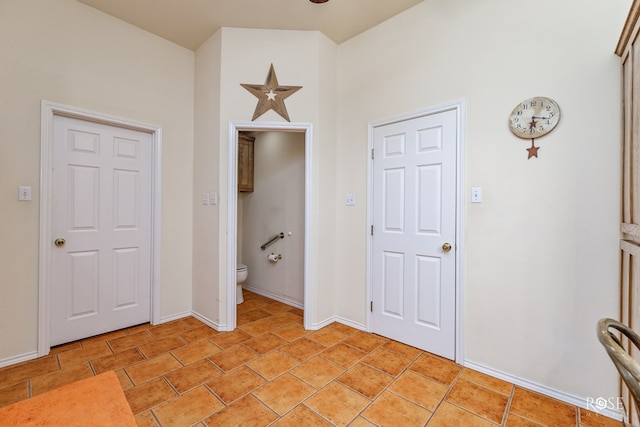 interior space featuring baseboards and light tile patterned floors