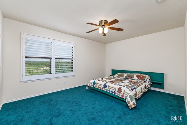 carpeted bedroom with ceiling fan and baseboards