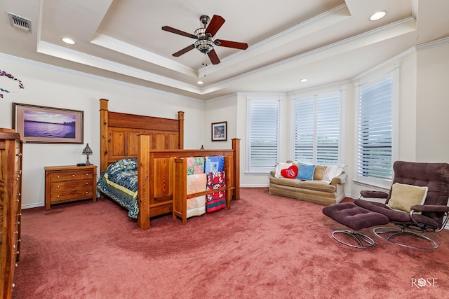 carpeted bedroom featuring visible vents, a raised ceiling, and ornamental molding