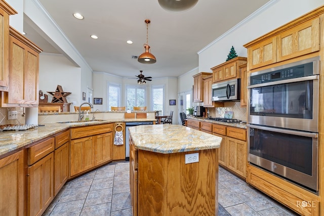 kitchen with a peninsula, ornamental molding, stainless steel appliances, and a center island