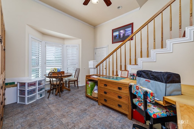 interior space with baseboards, ornamental molding, and a ceiling fan