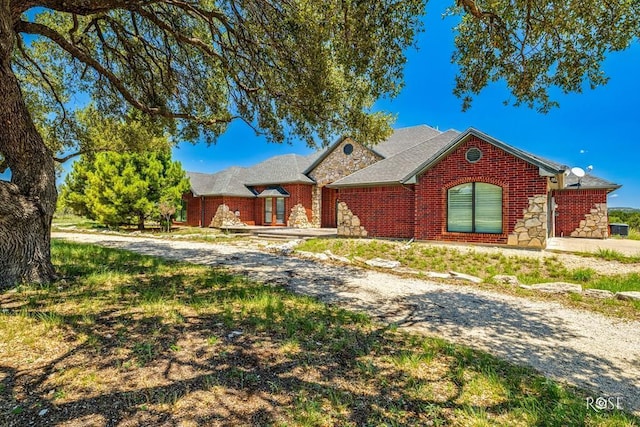 view of front of home with stone siding and brick siding