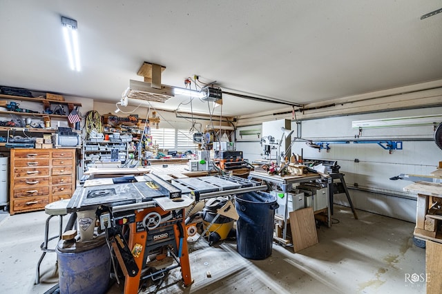 garage with a garage door opener and a workshop area