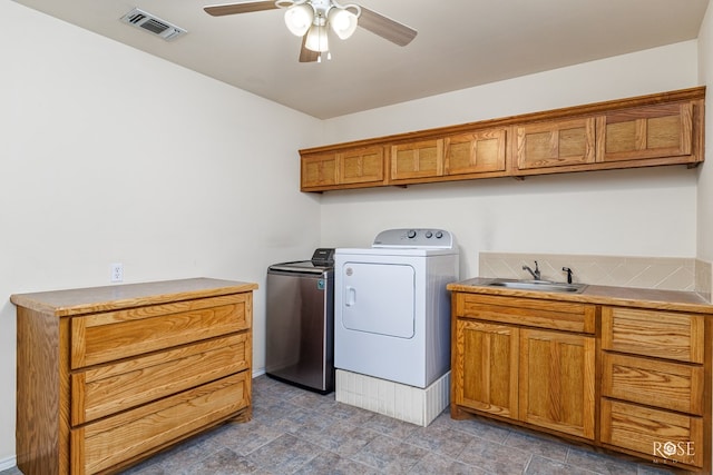 laundry room with ceiling fan, a sink, visible vents, washer and dryer, and cabinet space