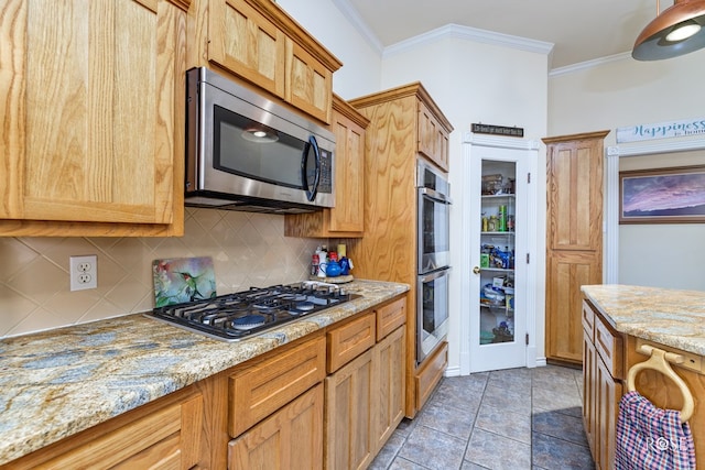 kitchen featuring stainless steel appliances, crown molding, backsplash, and light stone countertops