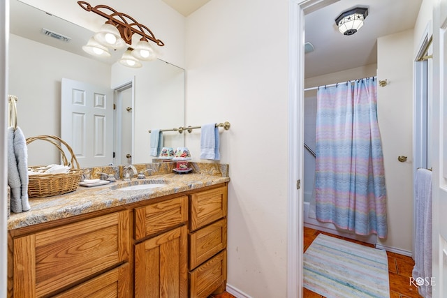 bathroom featuring visible vents, shower / tub combo with curtain, and vanity