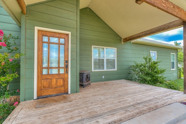 view of exterior entry with a wooden deck