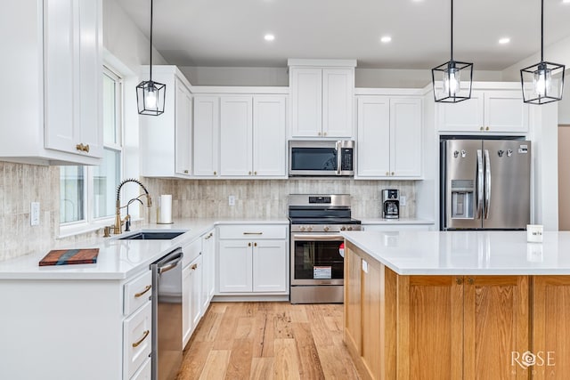 9401 Collett Rd, Robert Lee, TX 76945 - kitchen featuring stainless steel appliances, light wood-style floors, light countertops, white cabinetry, and recessed lighting