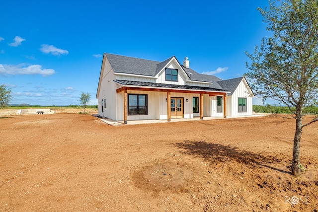 9401 Collett Rd, Robert Lee, TX 76945 - modern inspired farmhouse with board and batten siding, a chimney, a standing seam roof, roof with shingles, and a metal roof
