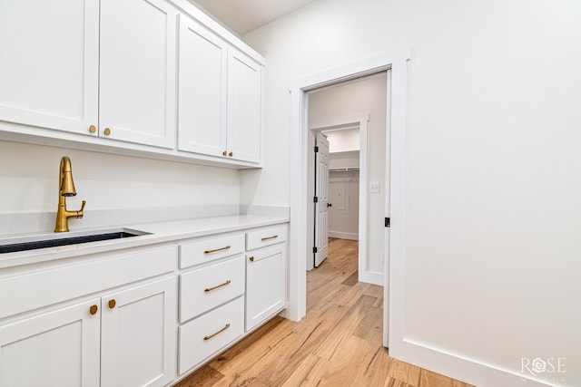9401 Collett Rd, Robert Lee, TX 76945 - kitchen featuring light wood-type flooring, white cabinetry, and light countertops