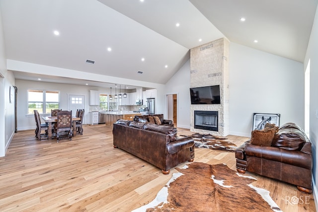9401 Collett Rd, Robert Lee, TX 76945 - living room featuring high vaulted ceiling, light wood-style flooring, a fireplace, and recessed lighting
