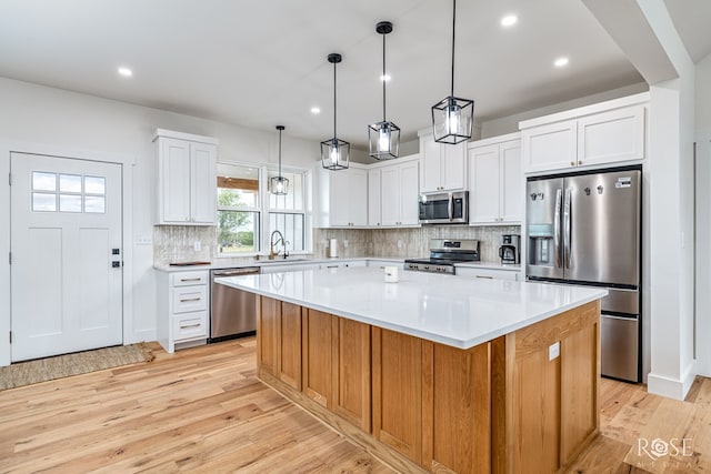 9401 Collett Rd, Robert Lee, TX 76945 - kitchen with stainless steel appliances, light wood-type flooring, a kitchen island, light countertops, and backsplash