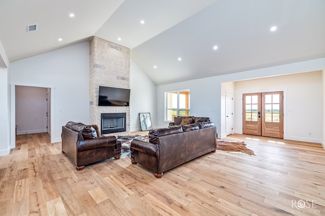 9401 Collett Rd, Robert Lee, TX 76945 - living room with high vaulted ceiling, a stone fireplace, light wood-style floors, and plenty of natural light