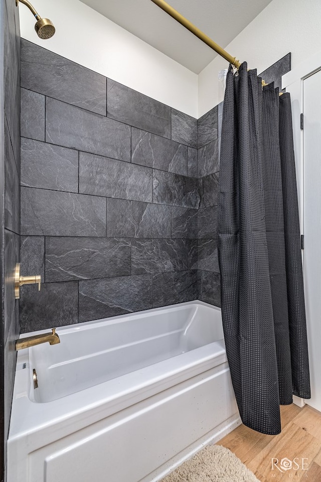 9401 Collett Rd, Robert Lee, TX 76945 - bathroom with shower / bath combo with shower curtain and wood finished floors