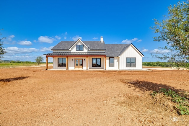9401 Collett Rd, Robert Lee, TX 76945 - modern farmhouse with a standing seam roof, board and batten siding, french doors, a metal roof, and roof with shingles
