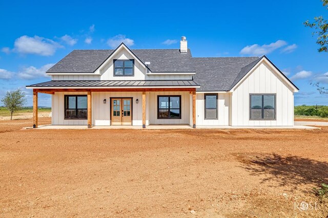 9401 Collett Rd, Robert Lee, TX 76945 - modern inspired farmhouse with board and batten siding, french doors, a standing seam roof, and a shingled roof