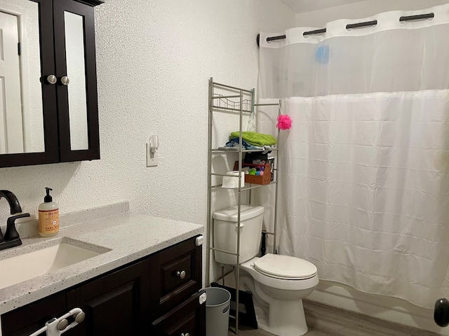 201 N Franklin St, Bronte, TX 76933 - full bath with toilet, vanity, a textured wall, wood finished floors, and a shower with curtain