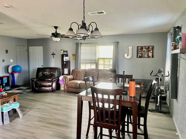 201 N Franklin St, Bronte, TX 76933 - dining space with light wood-style floors, a textured ceiling, ceiling fan, and a chandelier