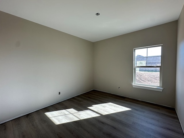 spare room with dark wood-style floors