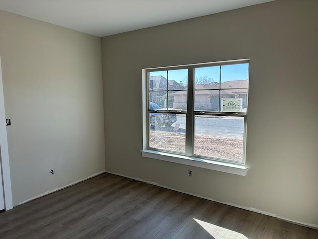 unfurnished room with wood finished floors