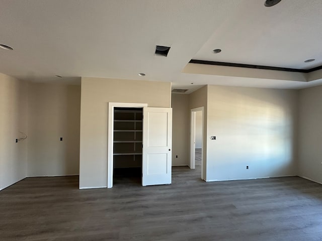 unfurnished bedroom featuring a closet and dark wood finished floors