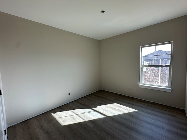 spare room with dark wood-type flooring