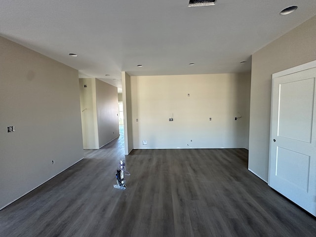 spare room featuring dark wood-style flooring