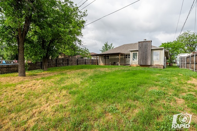 view of yard with a fenced backyard