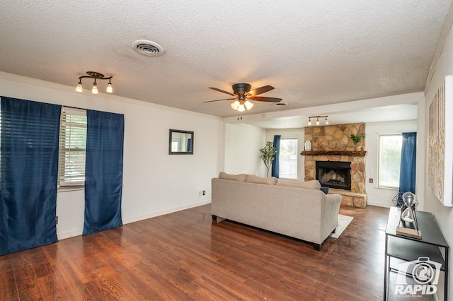 1016 N Adams Ave, San Angelo, TX 76901 - living room with visible vents, a textured ceiling, ceiling fan, and wood finished floors