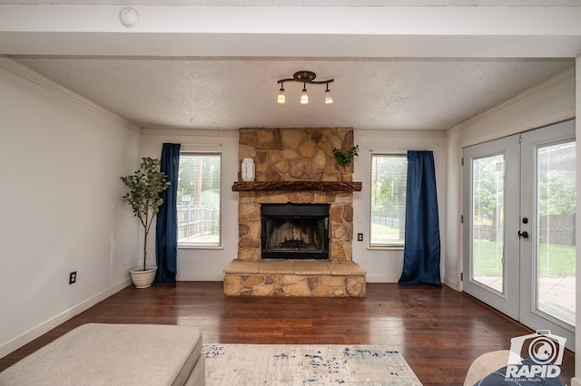 living room with ornamental molding, a fireplace, french doors, and wood finished floors