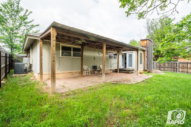 1016 N Adams Ave, San Angelo, TX 76901 - rear view of property with a lawn, central air condition unit, a fenced backyard, and a patio area
