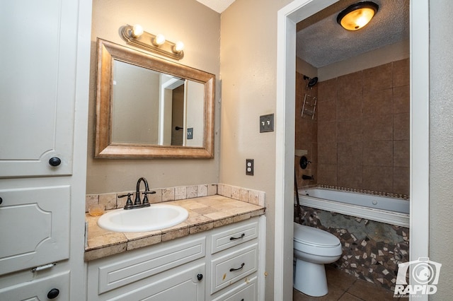 bathroom featuring vanity, tile patterned flooring, bathing tub / shower combination, and toilet