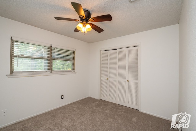 unfurnished bedroom featuring carpet floors, a textured ceiling, ceiling fan, and a closet