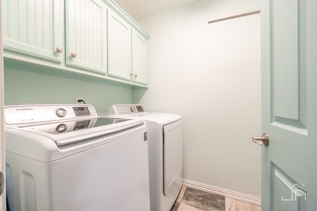 3067 Champions Cir, San Angelo, TX 76904 - laundry room featuring washing machine and dryer, cabinet space, and baseboards