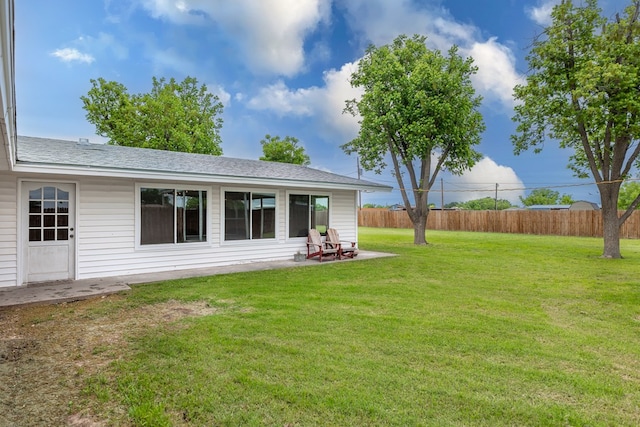 view of yard featuring fence and a patio