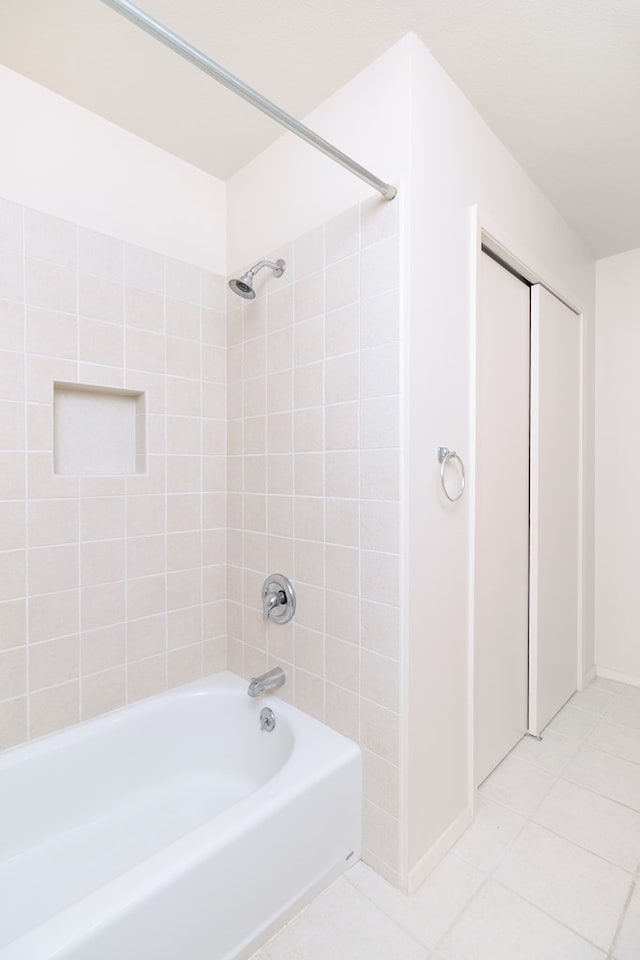 bathroom featuring baseboards, tile patterned floors, and shower / bathing tub combination